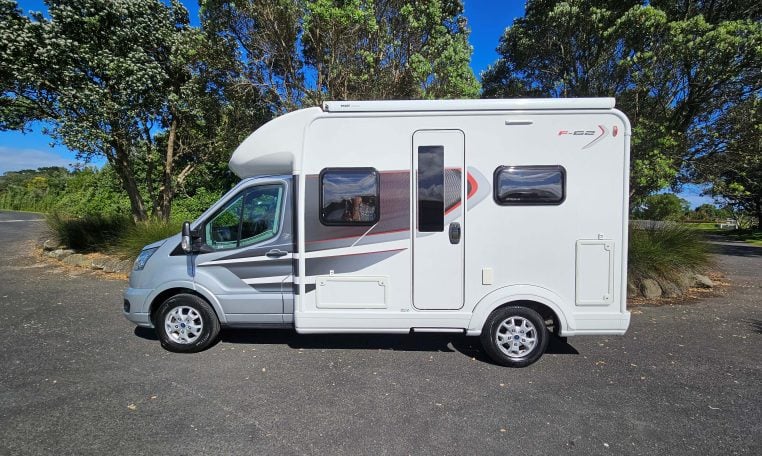 Exterior view of the Auto-Trail F-Line F62 motorhome showing the habitation door and surrounding side profile.