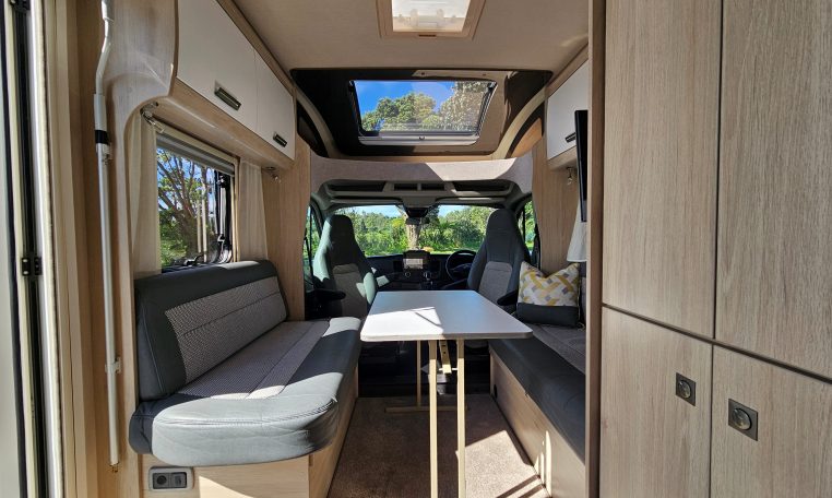 Auto-Trail F-Line F62 motorhome dining area with comfortable seating and a bright, open living space.