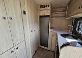 Auto-Trail F-Line F62 motorhome fridge built into the kitchen, offering convenient food storage on the road.