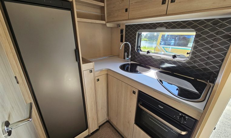 Compact Auto-Trail F-Line F62 motorhome kitchen with fridge, oven and smart storage cupboards