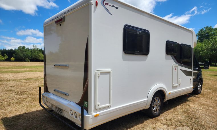2022 Pre-owned Auto-Trail F-Line F74 4-berth motorhome, exterior view of the back and driver's side.