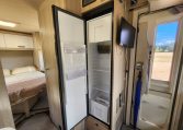 Pre-owned 2022 Auto-Trail F-Line F74 4-berth motorhome, interior view of the fridge with the door open.