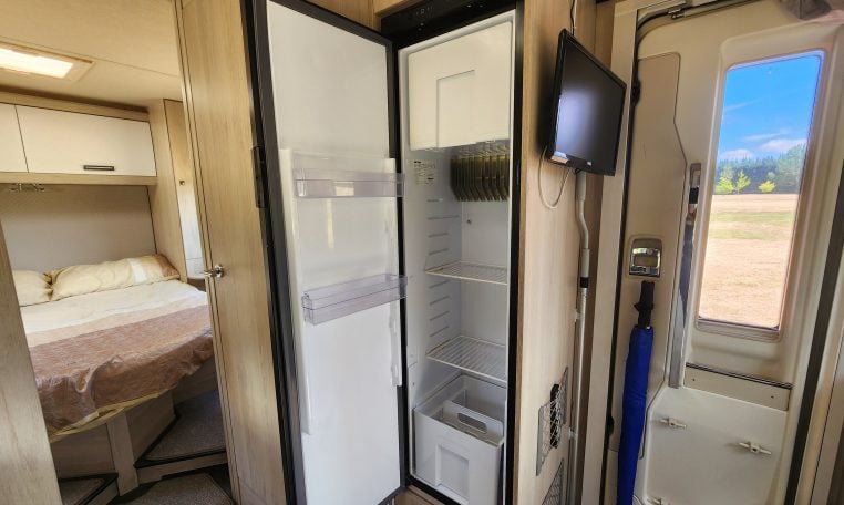 Pre-owned 2022 Auto-Trail F-Line F74 4-berth motorhome, interior view of the fridge with the door open.
