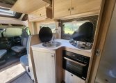 Pre-owned 2022 Auto-Trail F-Line F74 4-berth motorhome, interior view of the kitchen with the stove and oven.
