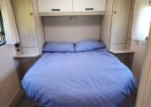 Pre-owned 2022 Auto-Trail F-Line F74 4-berth motorhome, interior view of the spacious fixed rear island bed.