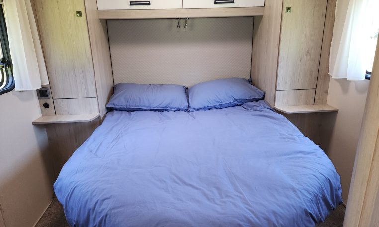 Pre-owned 2022 Auto-Trail F-Line F74 4-berth motorhome, interior view of the spacious fixed rear island bed.