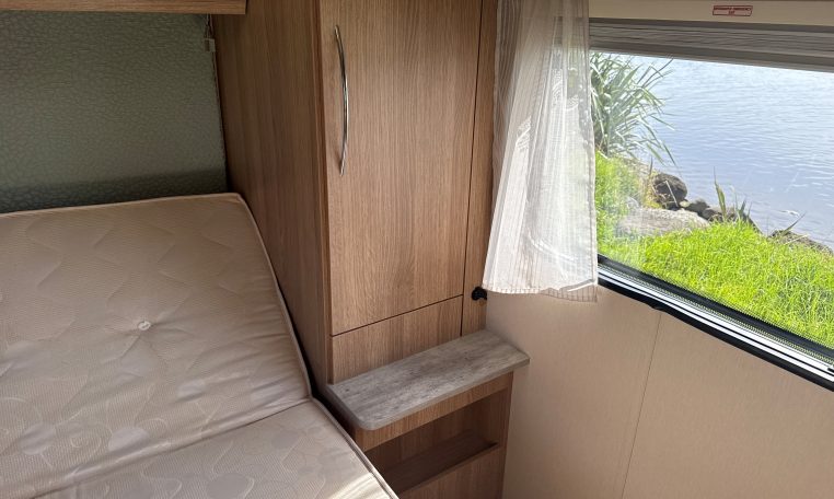 2022 Auto-Trail Imala 730 motorhome interior showing the bedroom cupboard for convenient and tidy clothing storage.