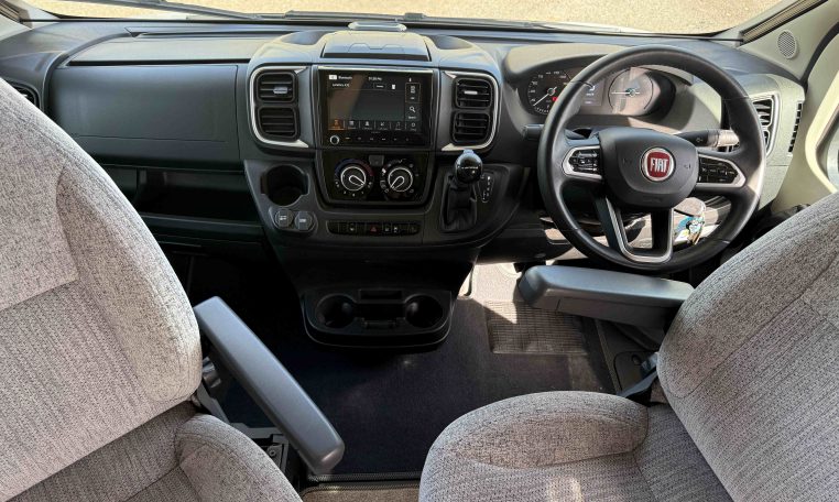 2022 Auto-Trail Imala 730 motorhome interior showing the front cab steering wheel and dash.