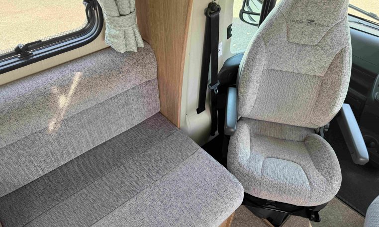 2022 Auto-Trail Imala 730 motorhome interior showing the cab swivel seats providing extra seating in the living space.