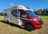 Side front view of a 2022 Auto-Trail Tracker RL motorhome showing the driver's door and sleek cab exterior.