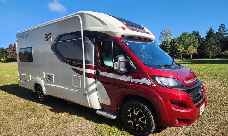 Side front view of a 2022 Auto-Trail Tracker RL motorhome showing the driver's door and sleek cab exterior.
