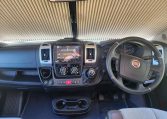 Cab and dashboard of the 2022 Auto-Trail Tracker RL motorhome showing driver and passenger seats with controls and steering wheel.