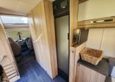 2022 Auto-Trail Tracker RL motorhome fridge built into the kitchen, offering convenient food storage on the road