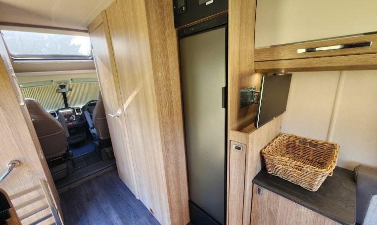 2022 Auto-Trail Tracker RL motorhome fridge built into the kitchen, offering convenient food storage on the road