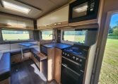 Compact 2022 Auto-Trail Tracker RL motorhome kitchen with hob, oven and smart storage cupboards.