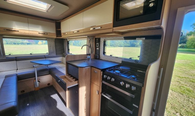 Compact 2022 Auto-Trail Tracker RL motorhome kitchen with hob, oven and smart storage cupboards.