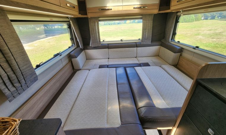 Rear lounge area in the 2022 Auto-Trail Tracker RL converting into a comfortable bed for flexible living.