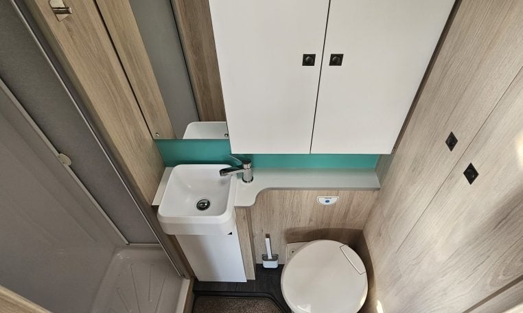 2022 Auto-Trail F-Line F-60 interior showing the compact motorhome bathroom with toilet, hand basin and separate shower.