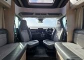 2022 Auto-Trail F-Line F-60 interior showing the cab swivel seats providing extra seating in the lounge area.