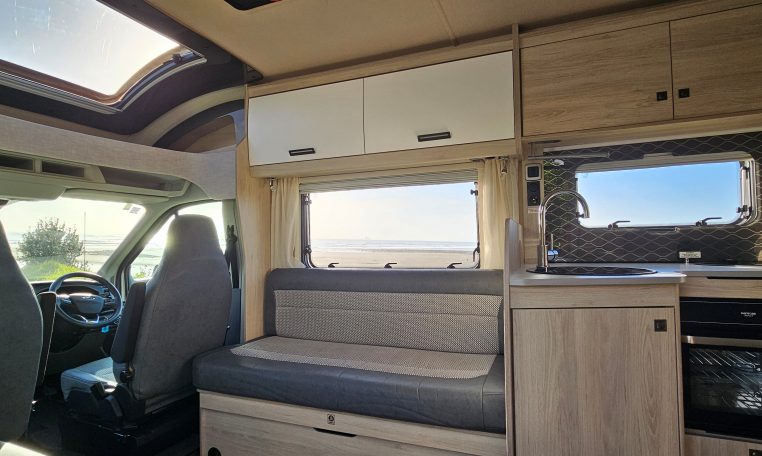 2022 Auto-Trail F-Line F-60 interior showing the front lounge overhead storage.