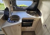 2022 Auto-Trail F-Line F-60 interior showing the kitchen with sink, hob and oven.