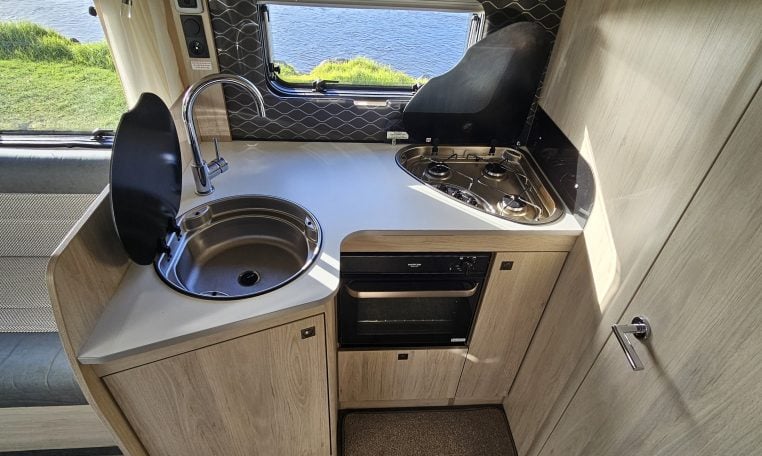 2022 Auto-Trail F-Line F-60 interior showing the kitchen with sink, hob and oven.