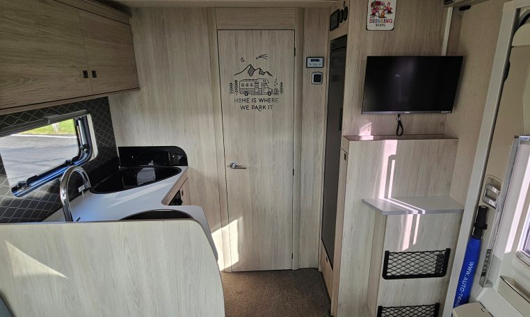 2022 Auto-Trail F-Line F-60 interior showing the kitchen overhead storage.