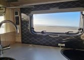 2022 Auto-Trail F-Line F-60 interior showing the kitchen window letting in natural light.