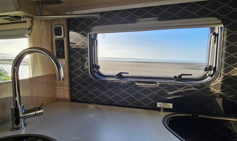 2022 Auto-Trail F-Line F-60 interior showing the kitchen window letting in natural light.