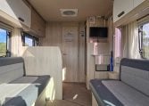 2022 Auto-Trail F-Line F-60 interior showing the lounge and kitchen layout.