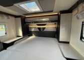 2022 Ci Magis 66XT interior view showing the spacious bedroom and overhead storage.