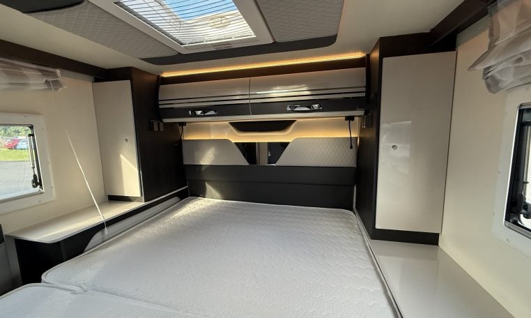 2022 Ci Magis 66XT interior view showing the spacious bedroom and overhead storage.