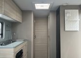 2023 Adria Altea Dart caravan interior view with overhead storage in the kitchen.