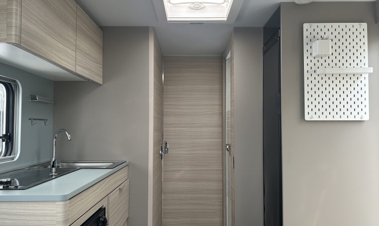 2023 Adria Altea Dart caravan interior view with overhead storage in the kitchen.