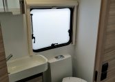 Interior view of the 2023 Adria Dart compact toilet and handbasin.