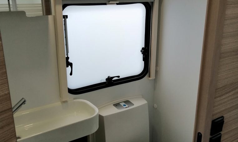 Interior view of the 2023 Adria Dart compact toilet and handbasin.