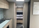 2023 Adria Altea Dart caravan interior view showing the rear bedroom from the front lounge.