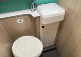 2023 Auto-Trail F74 Interior view of the bathroom with a toilet and handbasin.