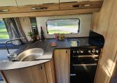2023 Auto-Trail Frontier Comanche interior view showing the compact motorhome kitchen.
