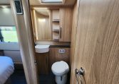 2023 Auto-Trail Frontier Comanche interior view of the toilet and handbasin in the bathroom.