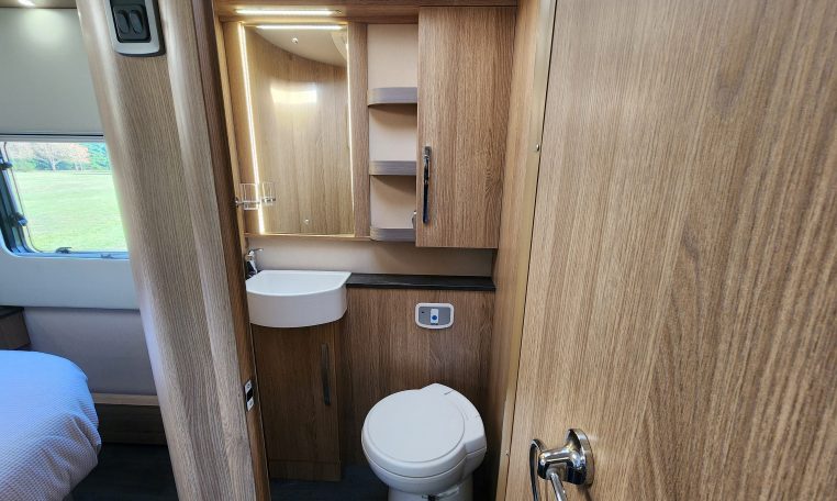 2023 Auto-Trail Frontier Comanche interior view of the toilet and handbasin in the bathroom.