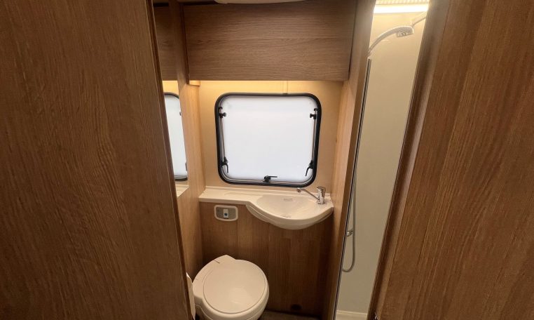 2023 Auto-Trail Imala 730 motorhome interior view showing the clean and compact bathroom.
