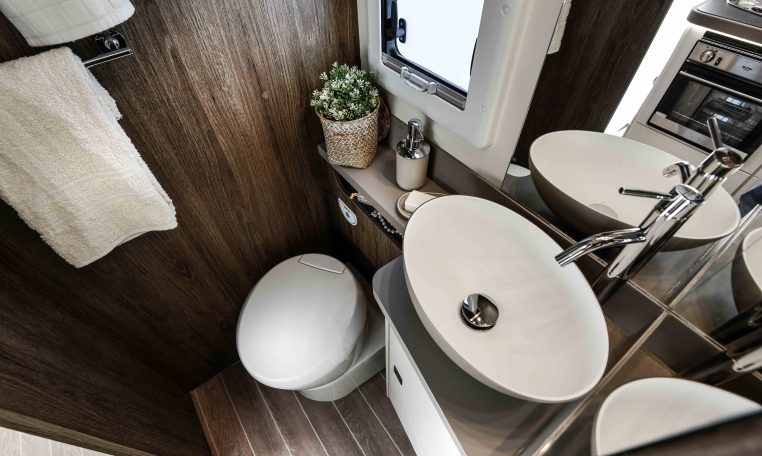 Interior view of the 2023 Roller Team Pegaso 745 bathroom with a toilet and handbasin.