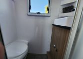 2023 Titan Blackhawk 720 Tardis interior view of the bathroom showing the toilet and handbasin.