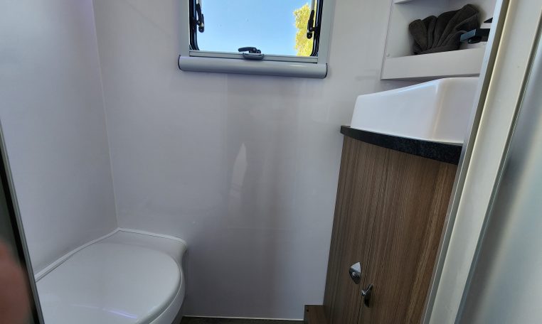 2023 Titan Blackhawk 720 Tardis interior view of the bathroom showing the toilet and handbasin.