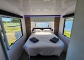 2023 Titan Blackhawk 720 Tardis interior view showing the spacious bedroom with an island bed.