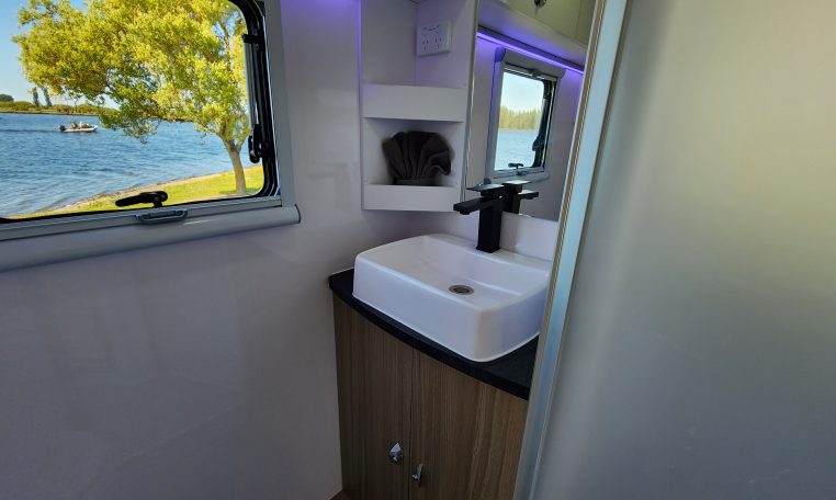 2023 Titan Blackhawk 720 Tardis caravan interior view showing the bathroom handbasin.