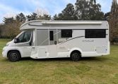 2023 Roller Team Auto-Roller 747 motorhome exterior side view showing the habitation door and awning.