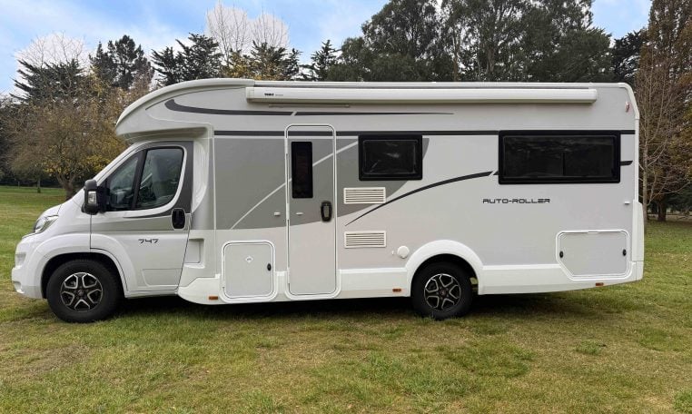 2023 Roller Team Auto-Roller 747 motorhome exterior side view showing the habitation door and awning.