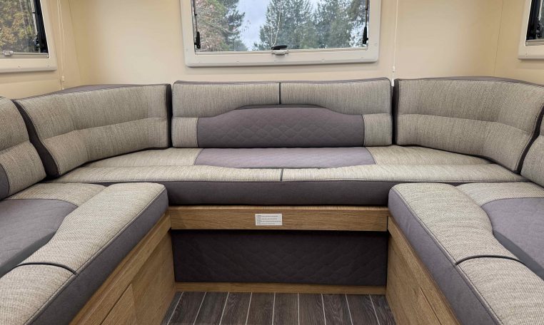 2023 Roller Team Auto-Roller 747 motorhome interior showing the rear u-shaped lounge.